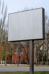 A gray, empty billboard on a city street.
