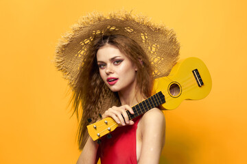 woman in red hat ukulele in hands lifestyle summer red t shirt yellow background