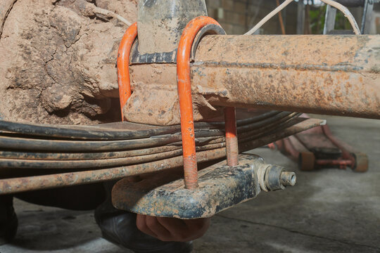 Car Mechanic or Auto Mechanic Tight U Bolt Nut to Hold Leaf Spring
