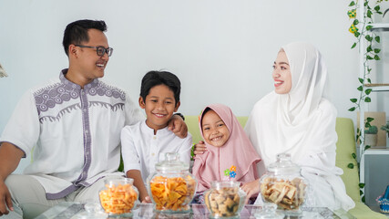 Asian Muslim families celebrate Eid together while enjoying a meal