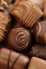 Chocolates assortment set.Chocolate sweets.Chocolate pattern. Candy brown background.dark milk chocolates set.Set of different chocolates.Sweet dessert