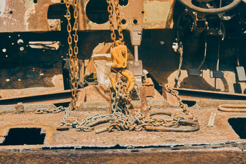 Reel and Chain and U Bolt and Automatic Gear Handle on Rusty Old Car Interior in Vintage Tone