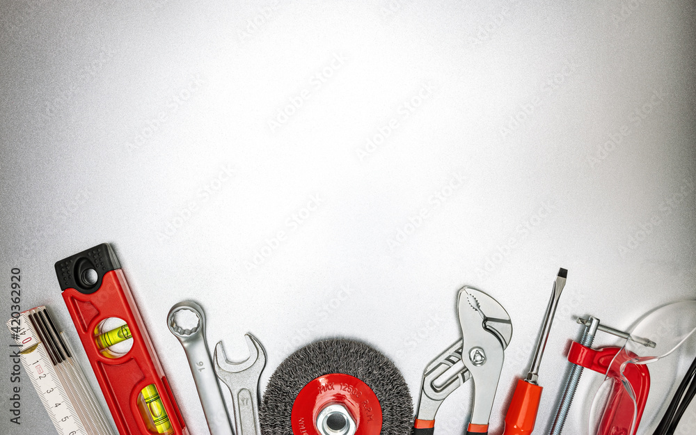 Sticker various renovation instruments and work tools on grey metallic desk. top view