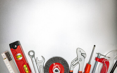 various renovation instruments and work tools on grey metallic desk. top view