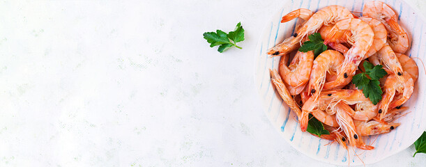 Prawns on bowl. Shrimps, prawns. Whole boiled shrimp. Seafood. Top view, banner, copy space