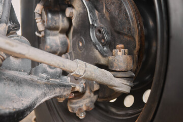 Back View Outer Tie Rod End and Inner Tie Rod End and Wheel Hub and Brake Caliper and Wheel and Tire and Lower Arm Ball Joint and Shock Absorber