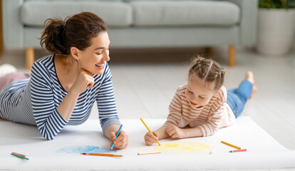 Mother and daughter are drawing