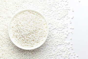 Close-up of organic white  sago or sabudana big size in white ceramic bowl with the gradient background of sago. Top view 

