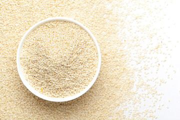 Close-up of White  Sesame seeds(Sesamum indicum) polished or white Til without shell in bowl with the gradient background of White  Sesame. Top view 