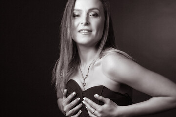 Fototapeta premium black and white portrait of an adult woman in a studio on a black background.