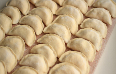 Homemade raw hand-made dumplings with potatoes on a cutting board