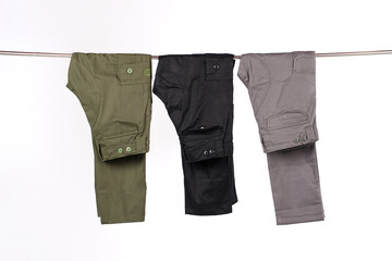 Men's cargo pants hanging and isolated on a white background. Mock up of plain cargo pants. Plain...