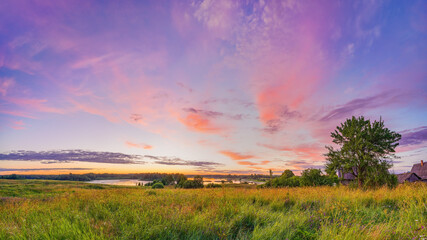 Colorful sunset over lake in countryside at spring