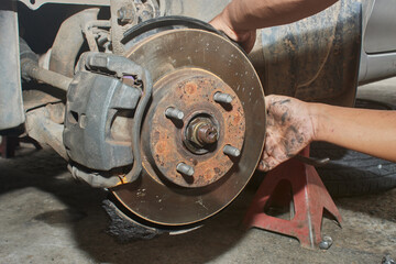 Fototapeta premium Car Mechanic Repair and Maintenance Front Wheel Hub in Car Repair Shop
