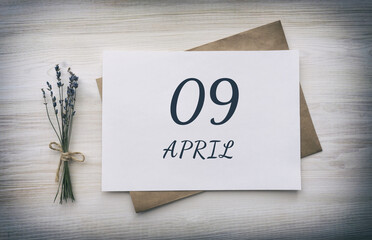 April 09. 09th day of the month, calendar date.White blank of paper with a brown envelope, dry...