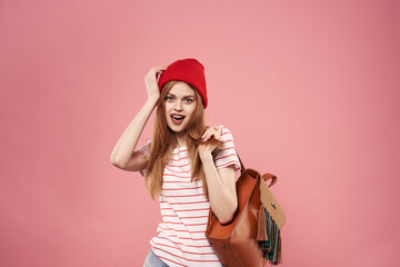 Cheerful fashionable woman in red hat emotions studio pink background