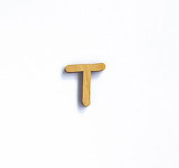 wooden letter t isolated on a white background, english alphabet from natural materials for children, eco friendly concept