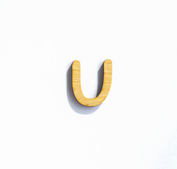 wooden classic letter u isolated on a white background, english alphabet from natural materials for children, eco friendly concept