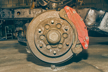 Car Wheel Hub and Brake System with Upper Arm Ball Joint and Chassis. Car Part or Auto Part in Car Repair Shop in Vintage Tone