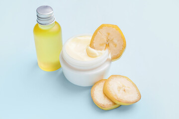 Natural banana cosmetics on color background