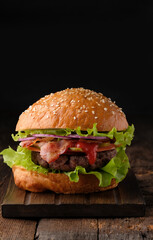 Close-up of home made tasty hamburger on wooden table.