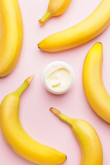 Jar of natural cream and fresh bananas on color background