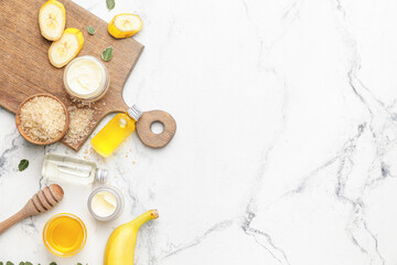 Composition with banana cosmetics on light background