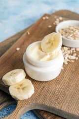 Composition with banana cream on color background, closeup