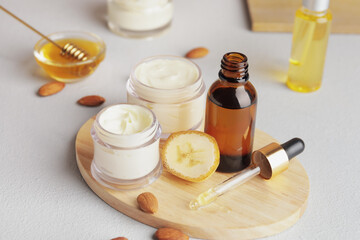 Composition with banana cosmetics on light background