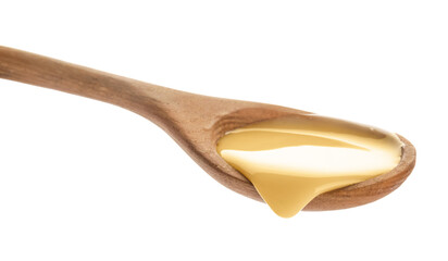 Wooden spoon of condensed milk on white background