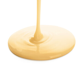 Pouring of condensed milk on white background