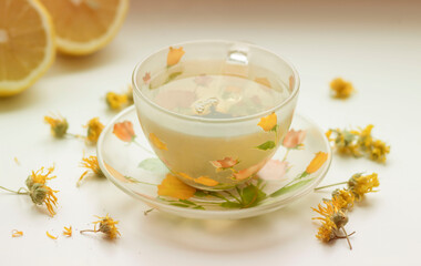 Green tea in a beautiful cup, with lemon and ginger