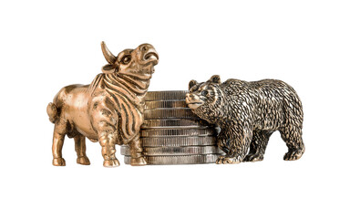Isolated image of yellow metal bull and bear figurines against the background of a stack of coins. The concept of the symbol of stock trading, the struggle of buyers and sellers. A series of images.