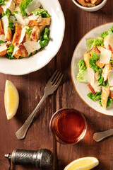 Caesar salad with wine and lemons, top flat lay shot