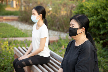 New normal lifestyle with social distancing needed even after vaccination, woman wearing face mask as new norm social distancing measure to prevent virus spread, coronavirus infection