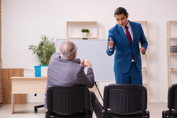 Two male employees in business meeting concept