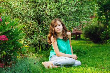 kid girl walking and relaxing in summer beautiful garden