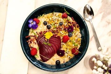 Poached pear, oats and fruit healthy breakfast