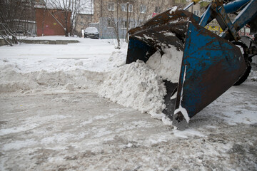 Snow plow and snow truck cleaning the streets during a snow storm in night maintenance action in...