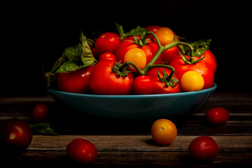 Fototapeta na wymiar Tomatoes in blue bowl