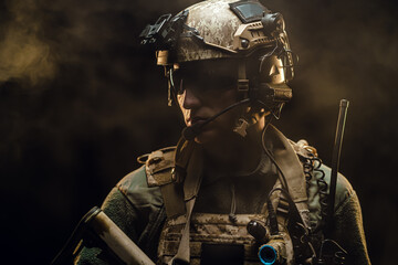 Special forces soldier with rifle on black background
