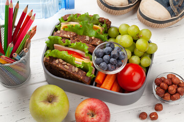 Healthy lunch box with sandwich and fresh vegetables