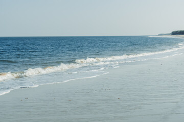 View of the beach at Beyt Dwarka in Gujarat, India. Sea waves crashing on the shore of the beach. Holiday relaxation concept. Sea waves at the shore, Relaxation at the beach. Summer travel background.