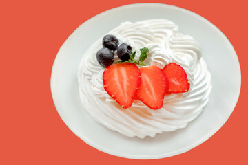 dessert Pavlova with strawberries. White airy cake. Cake Strawberry Red Background. Berries Decorating Dessert