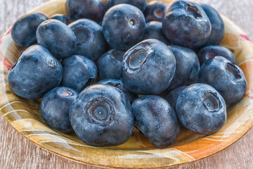 Fototapeta premium Fresh blueberries in a bowl. Close view.