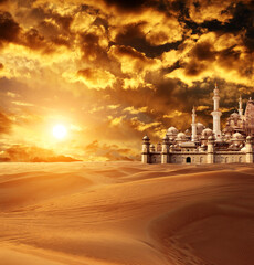Fantastic city in the sands on beautiful sunset sky background