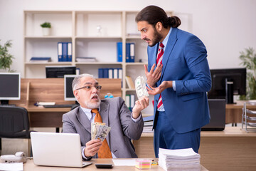 Old male boss and young male employee in remuneration concept