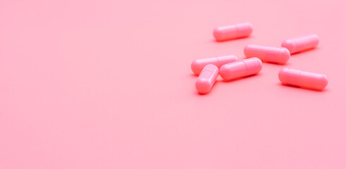 Pink capsules pill on pink background. Vitamins and supplements. Online pharmacy. Pharmacy store...