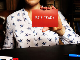 Business concept about FAIR TRADE with phrase on the piece of paper. An arrangement designed to...