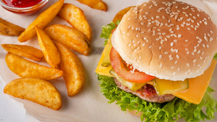 Burger with beef cutlet, cheese, onion, tomato and lettuce Street food
